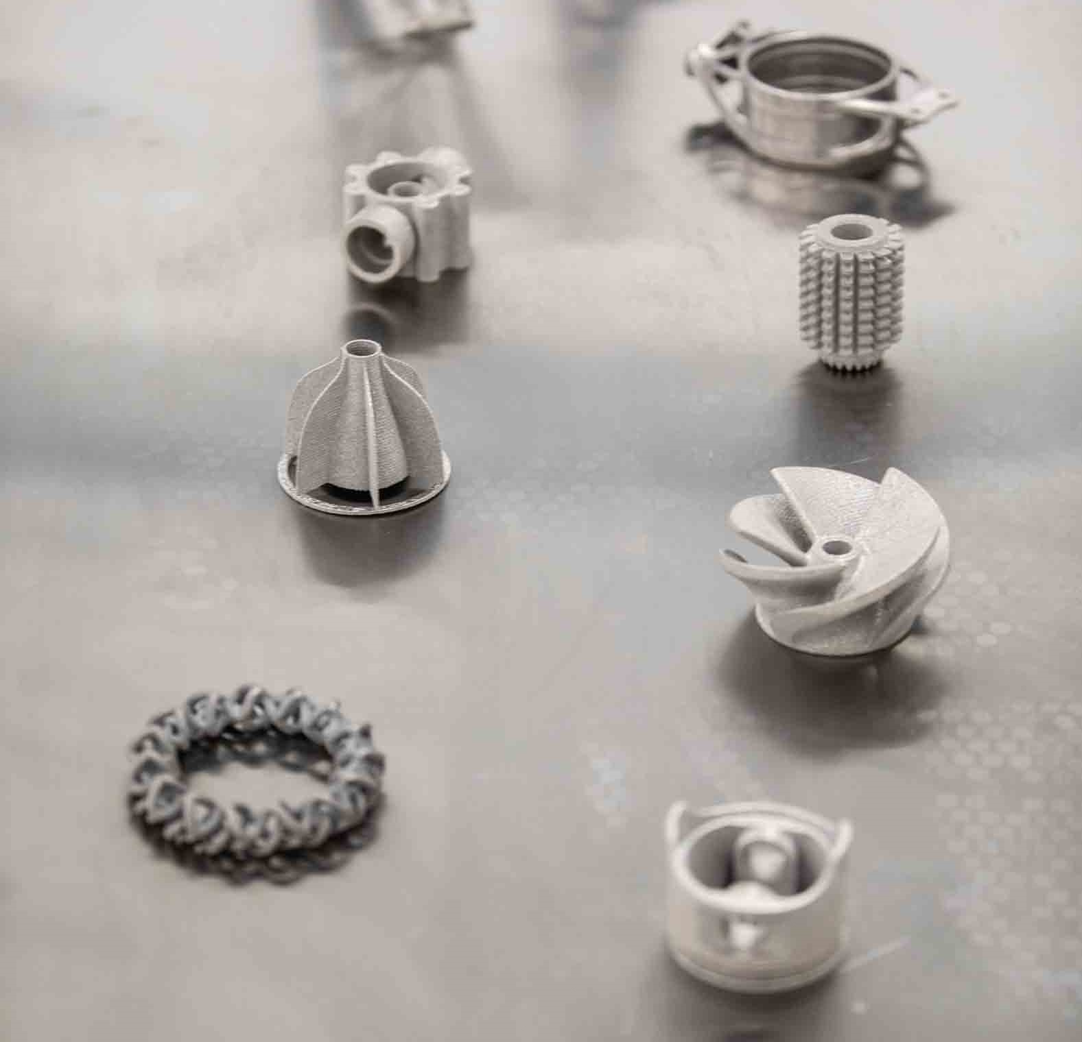 Image shows metal aircraft components on a table.